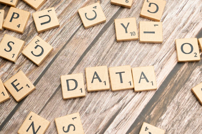 scrabble tiles spelling out the word data on a wooden surface